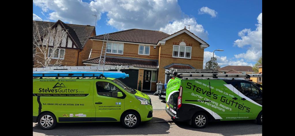 Technician installing new guttering system on residential property in Hertfordshire